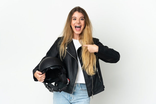 Mujer sosteniendo un casco de motocicleta aislado en un espacio en blanco con expresión facial sorpresa