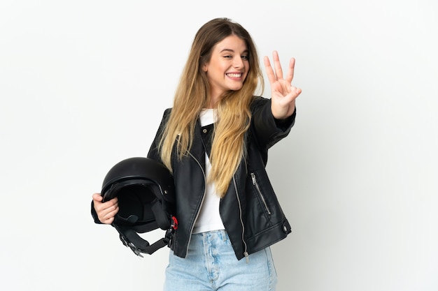 Mujer sosteniendo un casco de motocicleta aislado sobre fondo blanco feliz y contando tres con los dedos