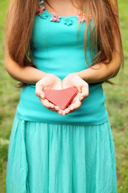 Mujer sosteniendo un corazón de papel