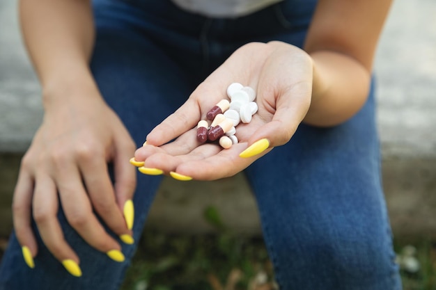 Mujer sosteniendo pastillas al aire libre