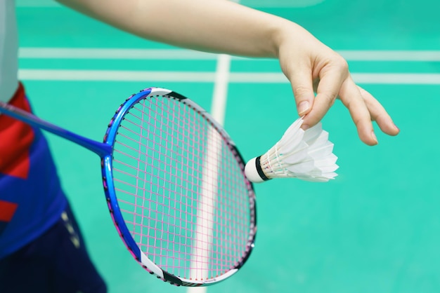 Mujer sosteniendo una raqueta de bádminton lista para golpear la llave de la cerradura