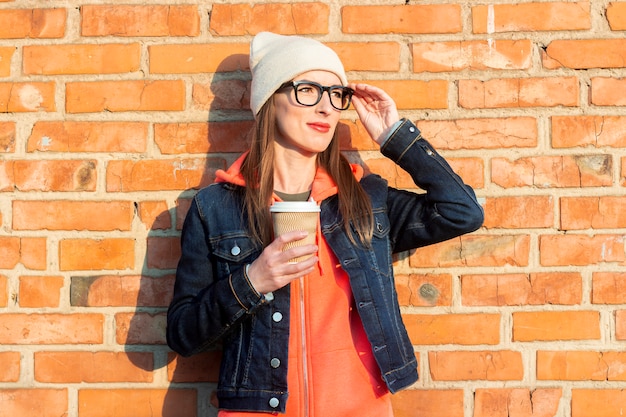 Mujer sosteniendo una taza de papel con café