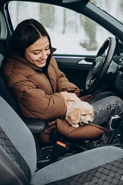 Mujer con su lindo perro sentado en el coche