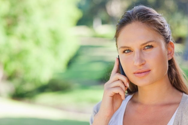 Mujer en su teléfono en el parque