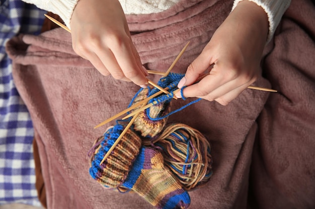 Mujer tejiendo calcetines pequeños