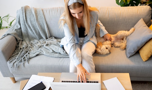 Mujer de tiro medio y perro en el interior