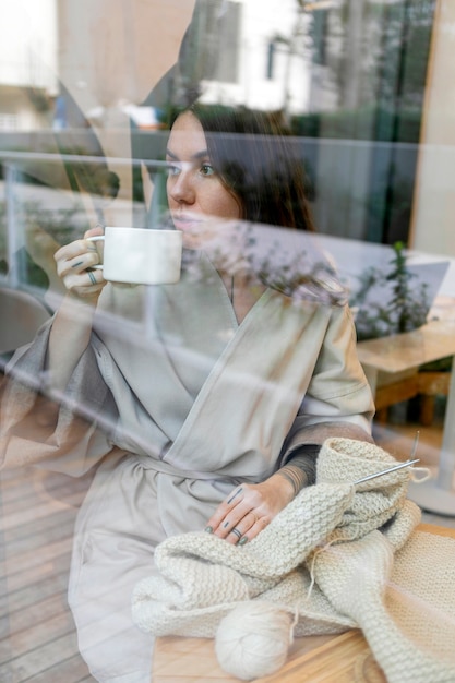 Mujer de tiro medio sosteniendo taza