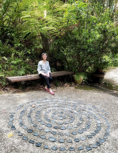 Foto mujer de toda la longitud de pie contra las plantas