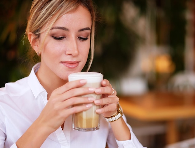 Mujer tomando café en la mañana en el restaurante