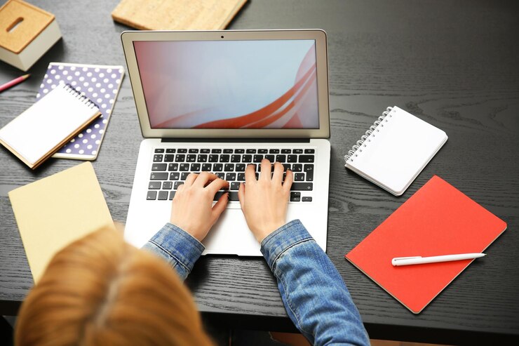 Foto mujer trabajando en una computadora portátil en el escritorio de la oficina