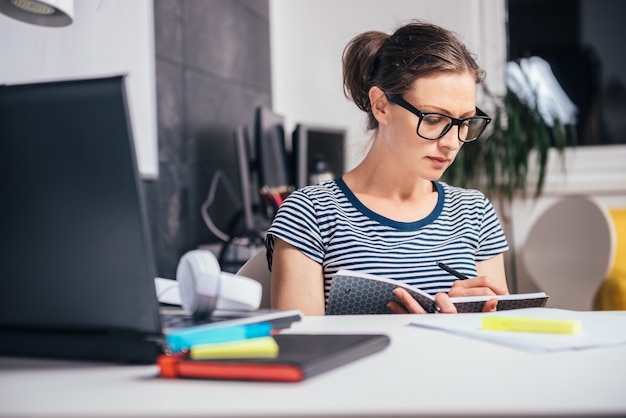 Mujer trabajando hasta tarde en la oficina