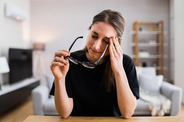 Foto mujer triste aburrida con dolor de cabeza