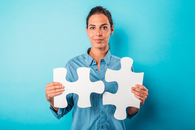 La mujer se une a la pieza del rompecabezas como concepto de integración de asociación de trabajo en equipo