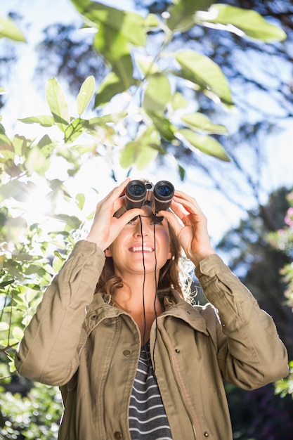 Foto mujer usando binoculares