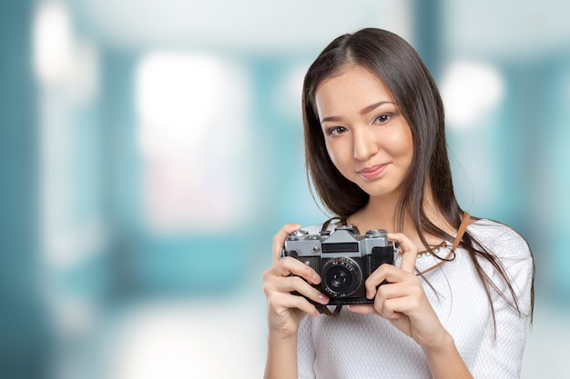 Mujer usando una cámara de fotos retro