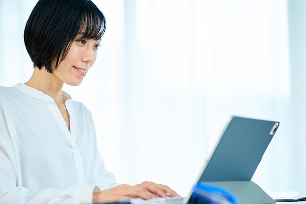 Mujer usando laptop en la habitación