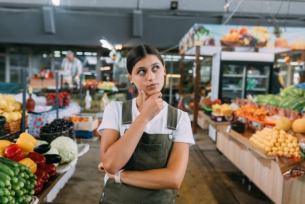 Mujer vendedora de fruta en el mercado cerca del mostrador