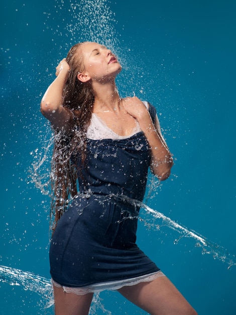 Mujer con un vestido azul con agua corriente