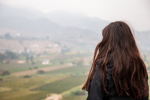 Mujer viajera de espaldas mirando al horizonte