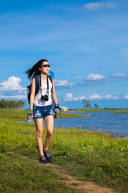 mujer viajero de pie cerca del lago en la montaña