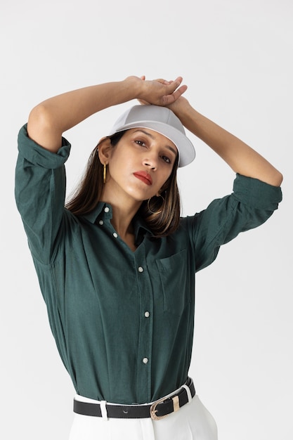 Foto mujer de vista frontal posando con sombrero de camionero