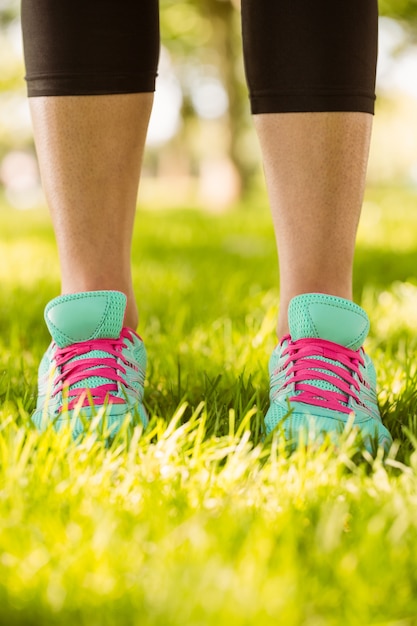 Mujer en zapatillas de pie en la hierba