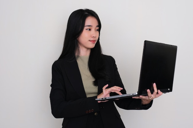 Mujeres asiáticas jóvenes mirando a una pantalla de computadora portátil que sostiene