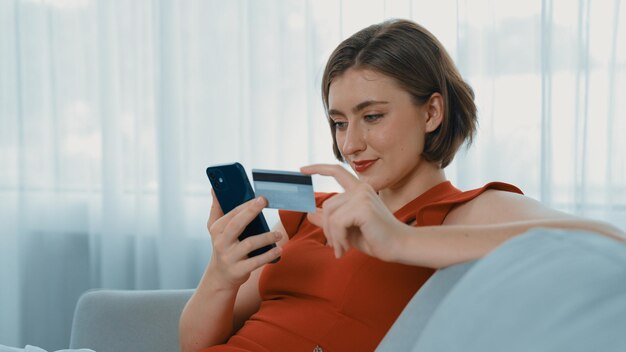 Las mujeres compran o pagan las facturas en línea en las compras primarias de Internet