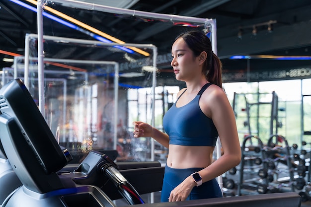 Las mujeres corren en una cinta en el gimnasio.