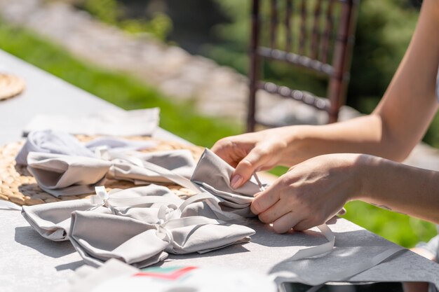 Foto mujeres diseñadoras decoran el lugar para la celebración de una ceremonia de boda al aire libre.