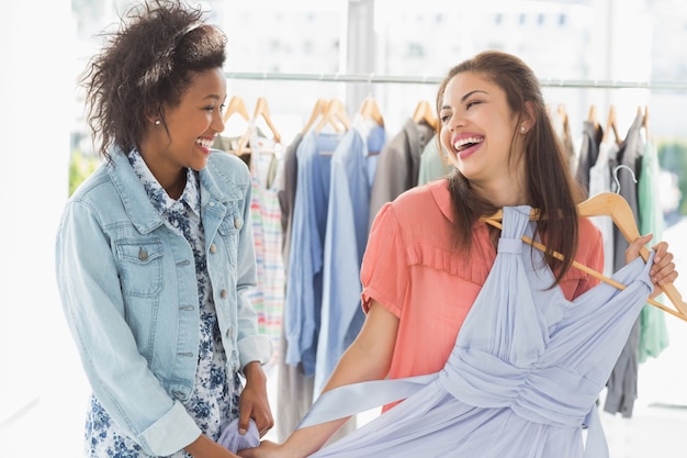 Foto mujeres felices de compras en la tienda de ropa