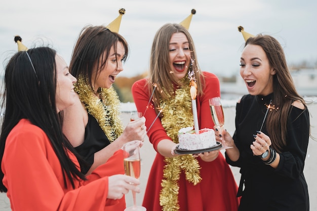 Mujeres felices con un pastel de cumpleaños