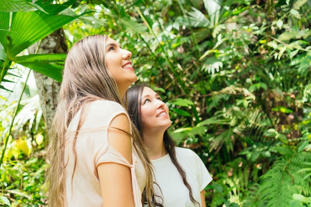 Mujeres hispanas, ambulante, en, bosque lluvioso