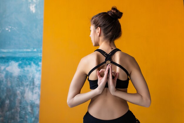 Mujeres jóvenes meditando con jnana mudra firmar en clase de yoga