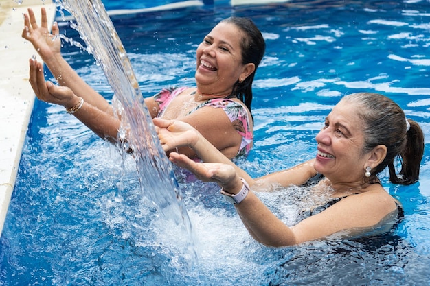 Mujeres maduras divirtiéndose en la piscina