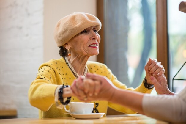 Mujeres mayores tomados de la mano