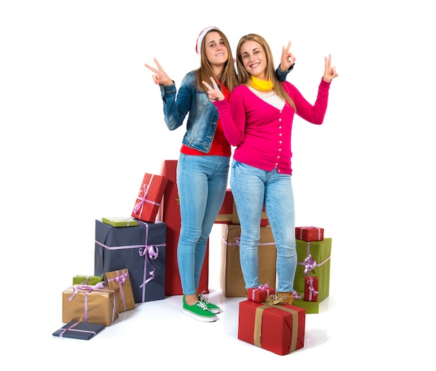 Mujeres de Navidad haciendo gesto de victoria sobre fondo blanco