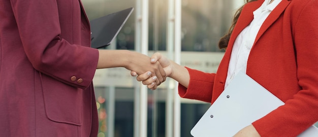 Mujeres de negocios dándose la mano después de una reunión