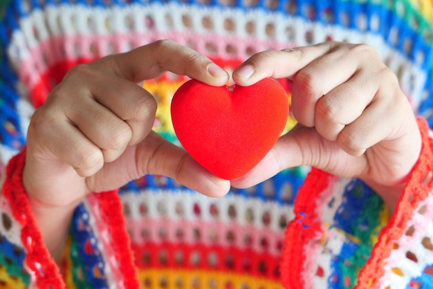 mujeres sosteniendo corazón rojo de cerca