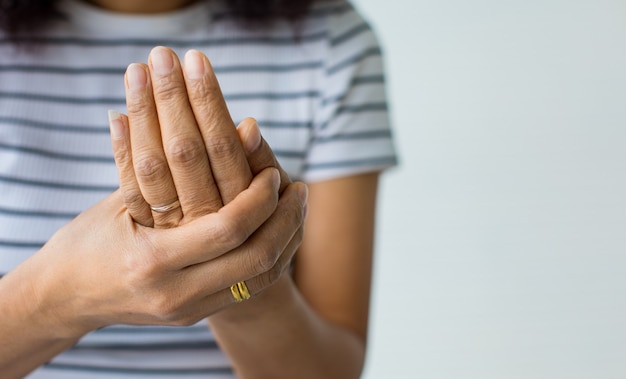 Las mujeres usan la mano para sostener la palma y los dedos con sensación de dolor, sufrimiento, dolor y hormigueo. Concepto de síndrome de Guillain barre y enfermedad de manos entumecidas.