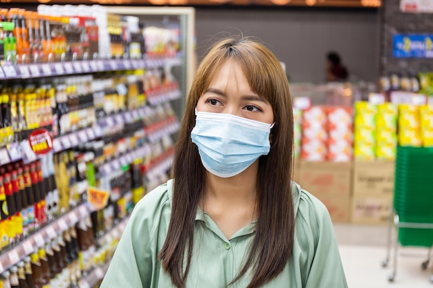 Las mujeres usan máscaras para comprar en los supermercados, nuevos estilos de vida normales en la era del virus Corona o la epidemia de Covid-19