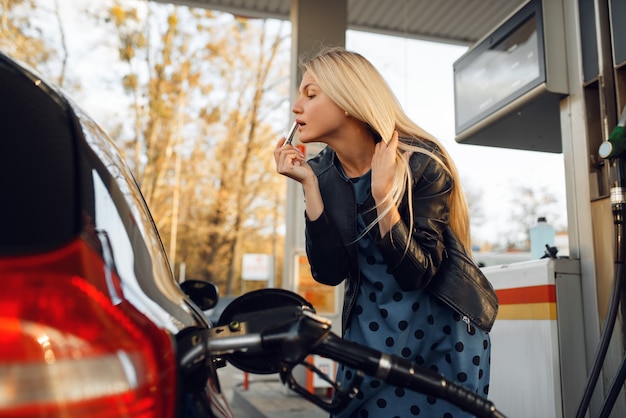 Mulher abastece o veículo no posto de gasolina, abastecimento de combustível. Abastecimento de gasolina, serviço de reabastecimento de gasolina ou diesel,