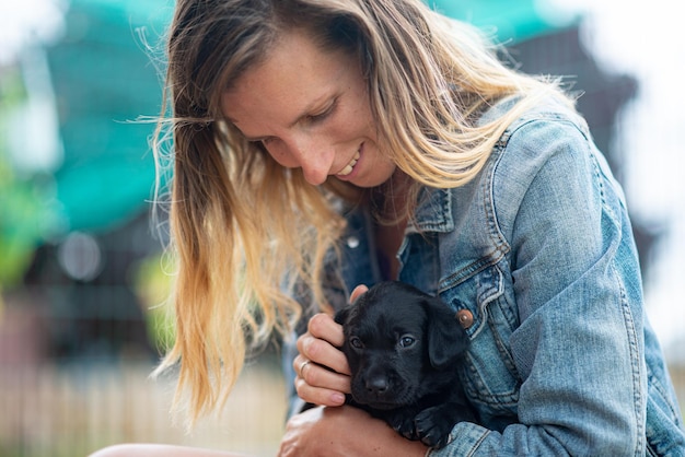 Mulher abraçando filhote de labrador