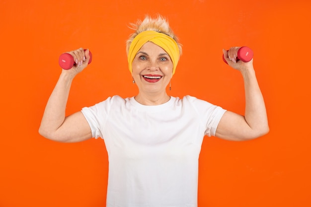 Mulher adulta aposentada pratica esportes com halteres