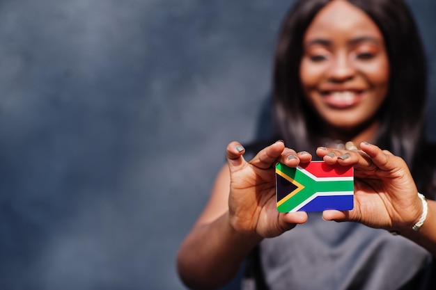 Foto mulher africana segura pequena bandeira da áfrica do sul nas mãos