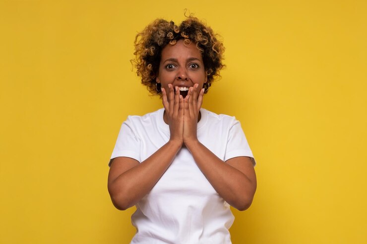 Mulher afro-americana com a mão na cabeça para dor na cabeça por causa do estresse que sofre de enxaqueca