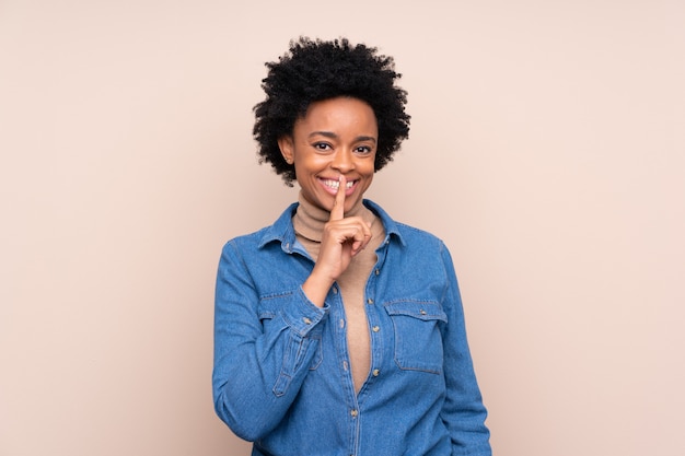 Mulher afro-americana sobre parede bege