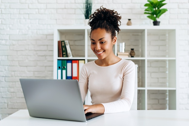 Mulher afro-americana trabalhando em um laptop