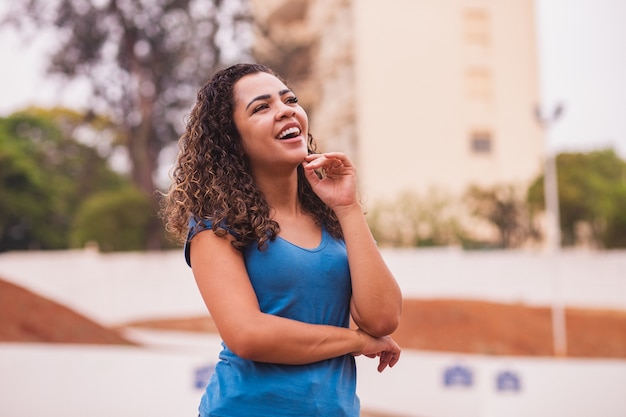 Mulher afro feliz para a câmera. jovem mulher afro sorrindo