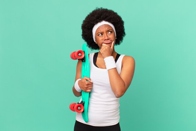 Mulher afro pensando, sentindo-se duvidosa e confusa, com diferentes opções, imaginando qual decisão tomar. conceito de skate